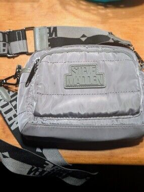 Steve Madden Light Gray Quilted Bag With Wide Branded Logo Strap.